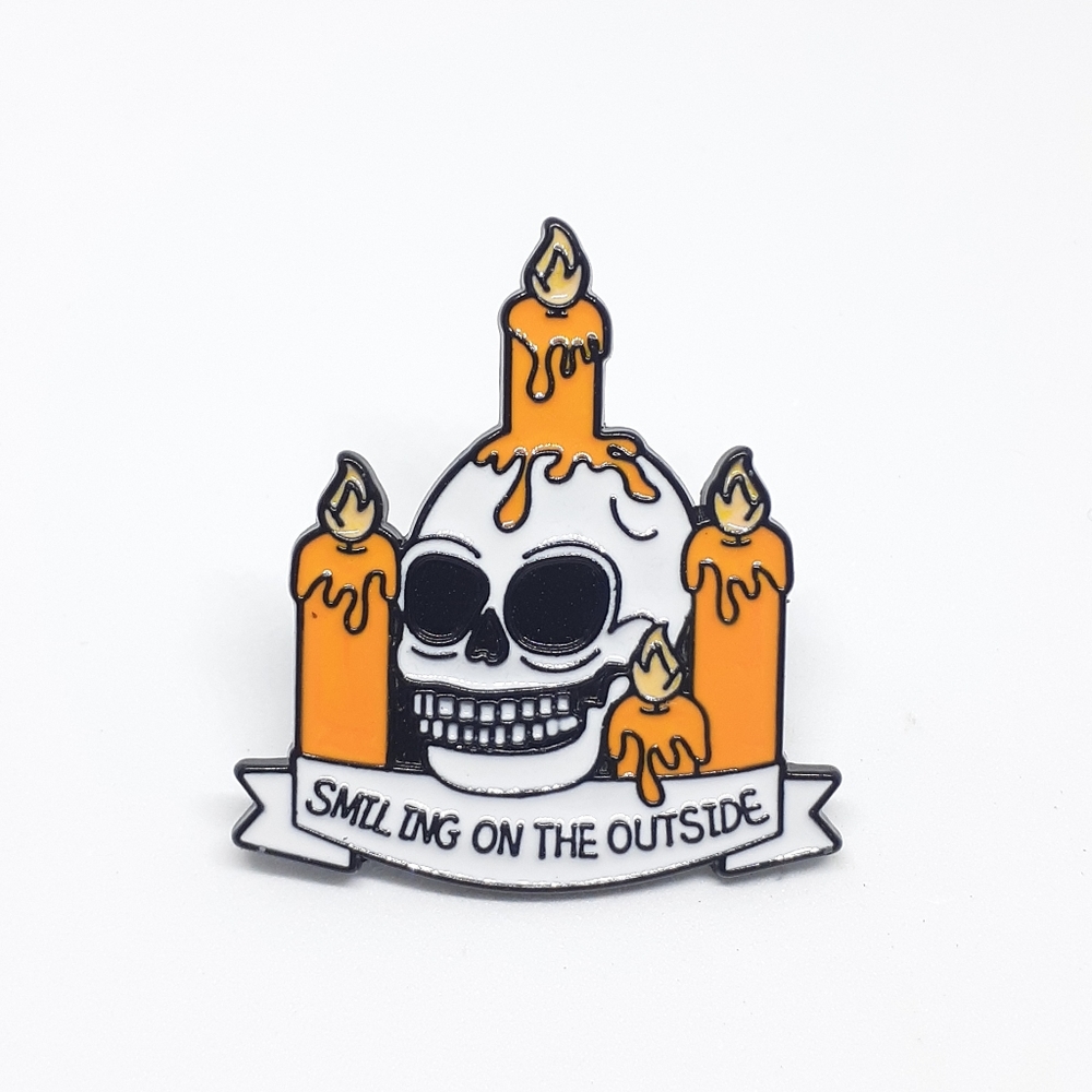 Smiling on the outside skull enamel pin